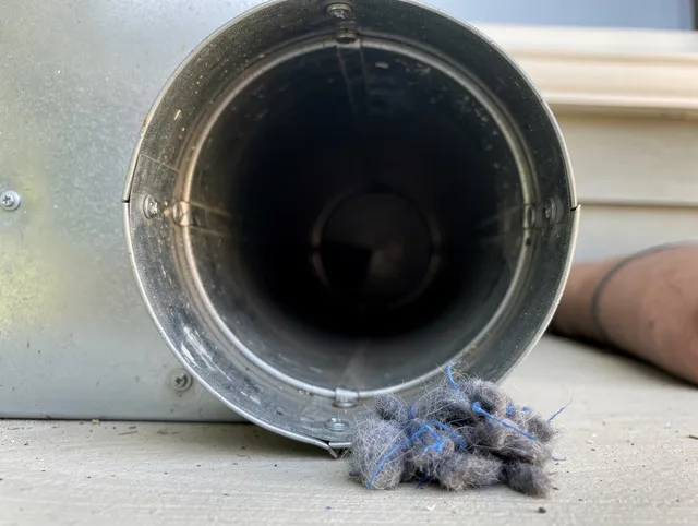 San Dimas Dryer Vent Cleaning technician using specialized equipment to clear severe dryer vent blockage in San Dimas